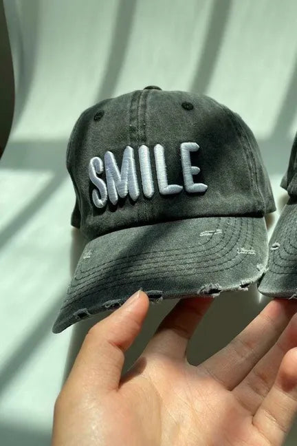 Charcoal ball cap with embroidered SMILE logo, curved brim, distressed sides