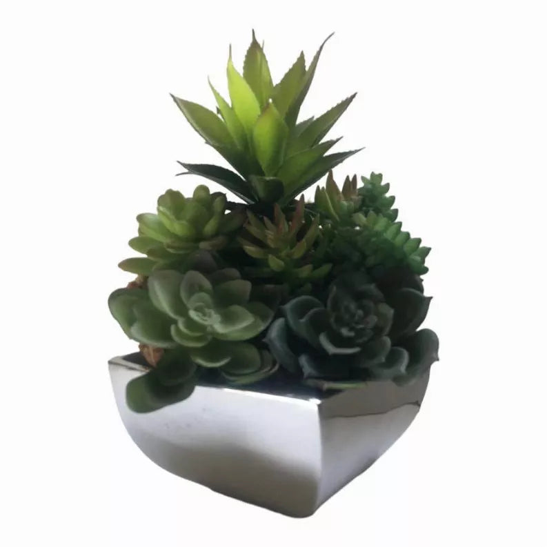 Decorative flower vase with faux succulents in a white rounded-square planter