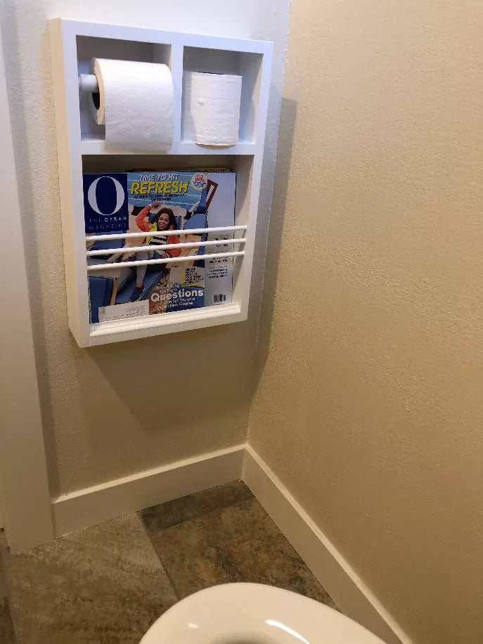 White toilet paper holder cabinet with two roll slots and open magazine shelf