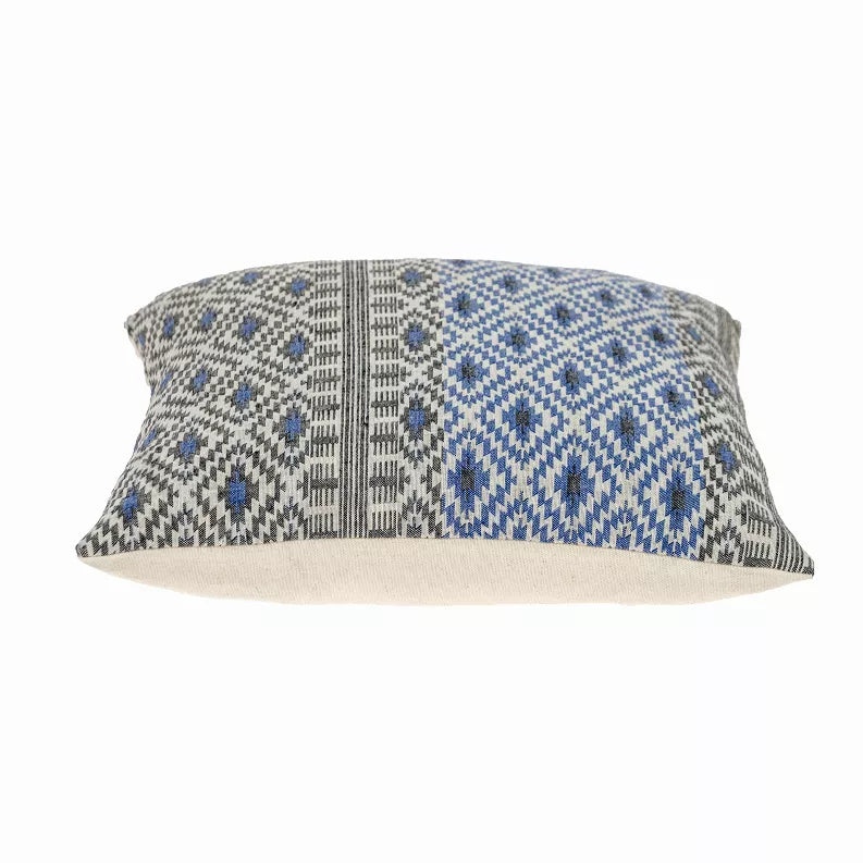 Rectangular view of blue and gray geometric throw pillow on beige background
