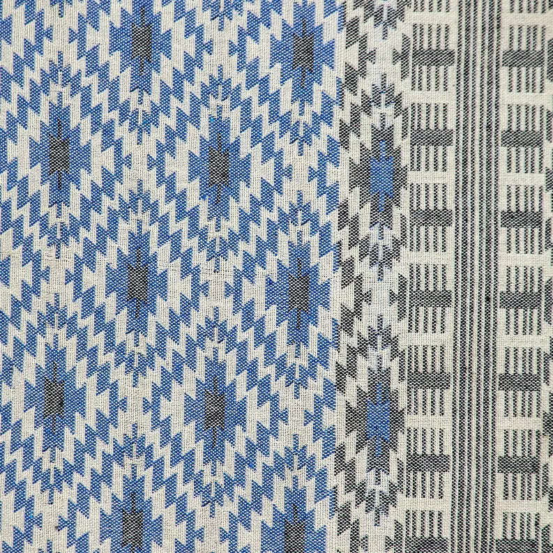 Close-up of throw pillow fabric with blue and gray geometric pattern on beige