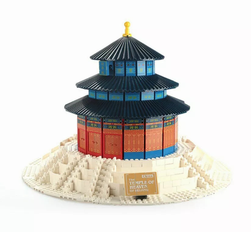 Miniature pagoda temple building model with dark blue roof and red walls on white base