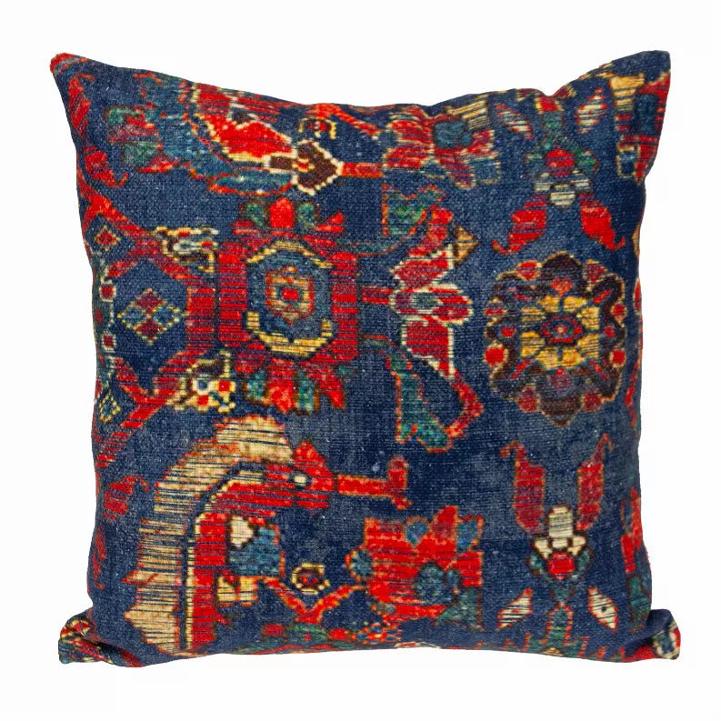 Square decorative pillow with navy blue tapestry design and multicolor red, gold motifs