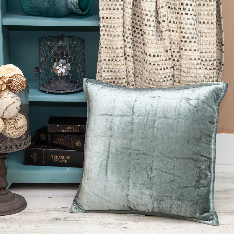 Sea foam solid quilted square throw pillow with smooth front and contrast piping.