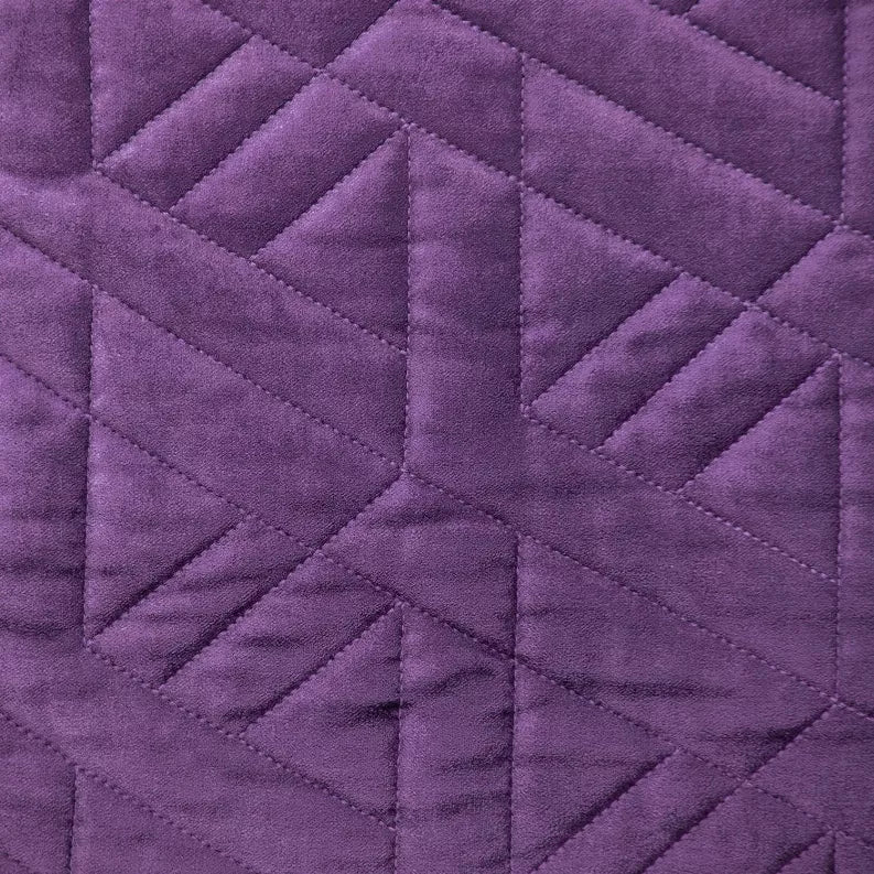 Purple quilted throw pillow fabric close-up with diamond channel stitching