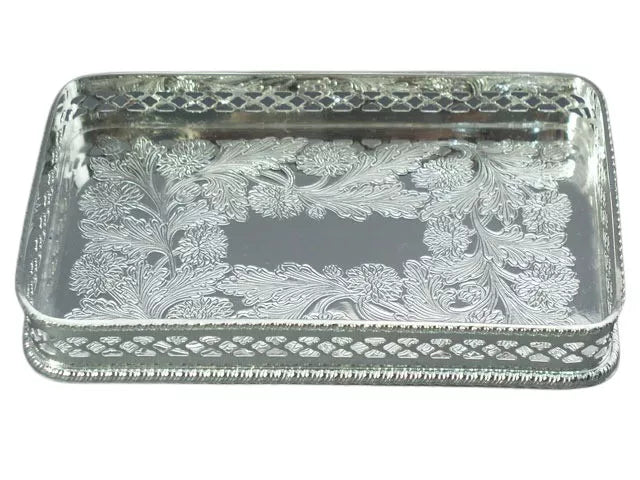 Silver rectangular card tray with ornate engraved scroll pattern and raised border