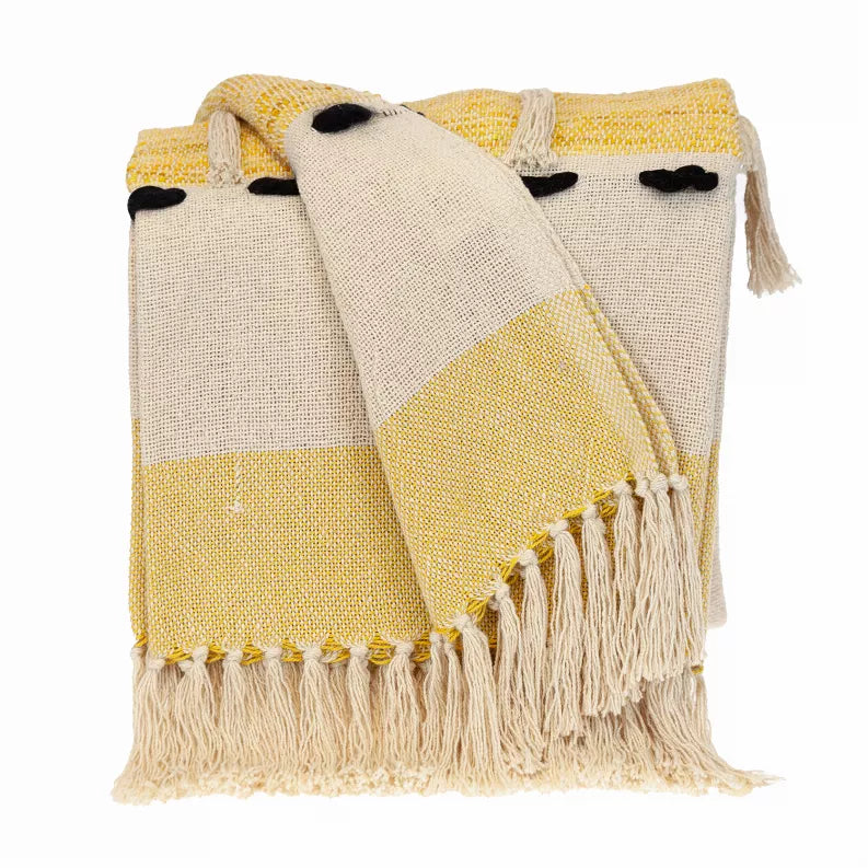 Yellow and cream throw blanket with black paw print pattern and fringe trim