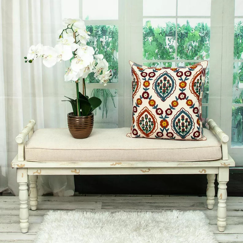 Multicolor embroidered throw pillow with symmetrical floral cactus medallions and red trim