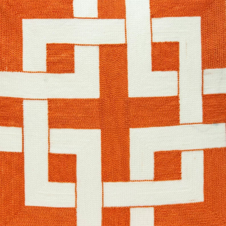 Close-up of orange fabric with bold white geometric block pattern