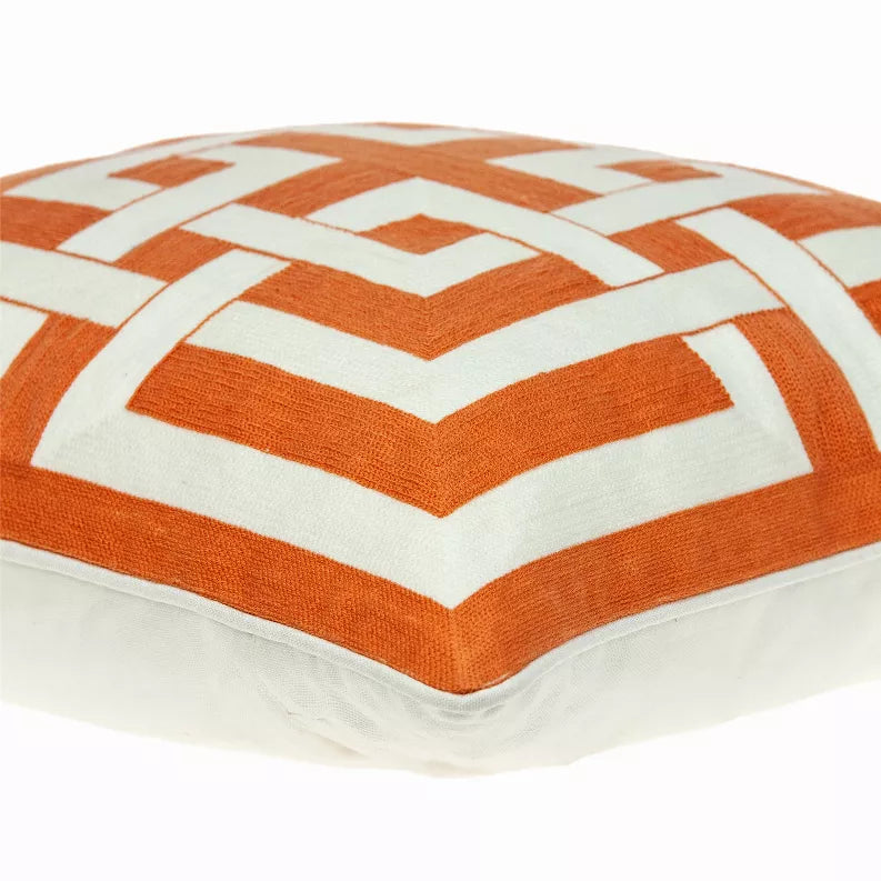 Orange and white geometric patterned throw pillow top view