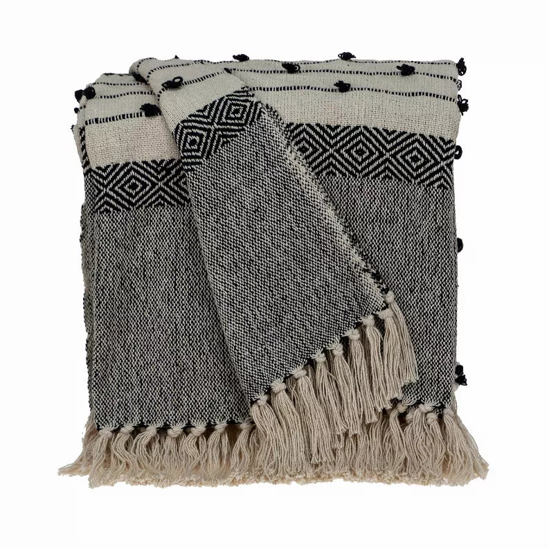Woven handloom throw with geometric pattern in beige and dark gray, with pom fringe