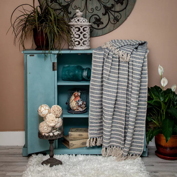 Woven handloom throw with blue and cream stripes and fringe ends, folded