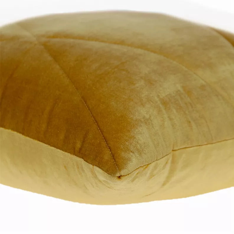 Yellow quilted throw pillow front corner with visible diamond seam and seam piping