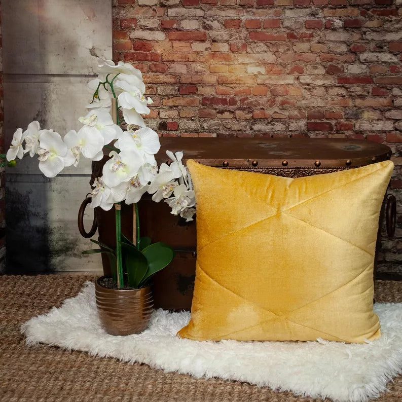 Yellow quilted throw pillow with crisscross diamond seam detail on a square cover