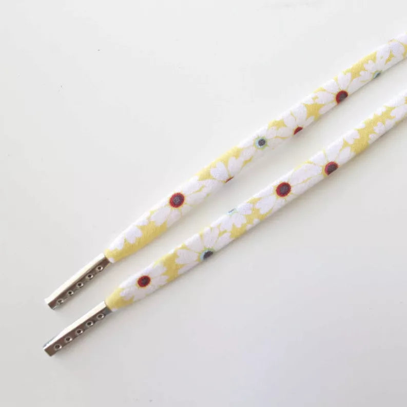 Floral print shoelaces with metal aglets, laid flat