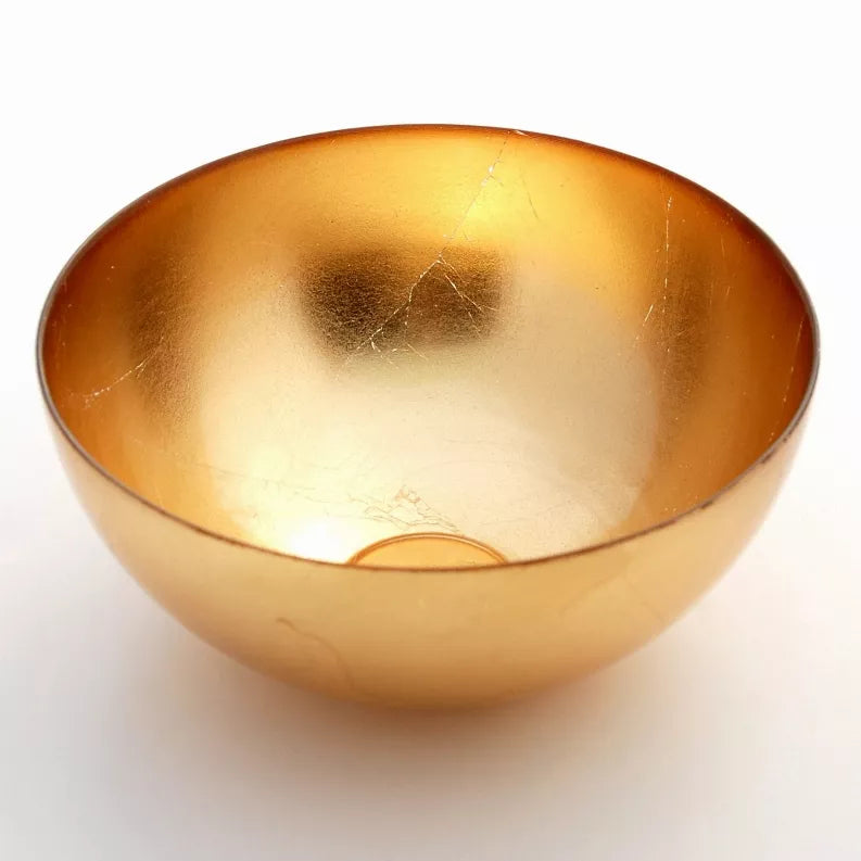 Gold tinted glass serve bowl with wide rim and reflective gilded finish