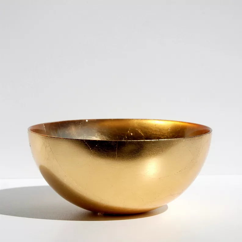 Gold glass serving bowl with shallow sides and smooth rim