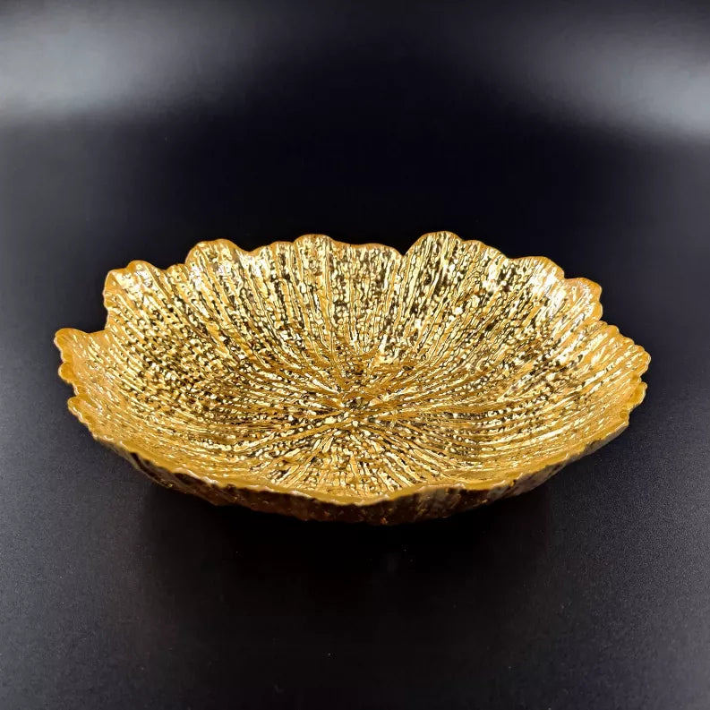 Gilded glass soup plate, angled view, shimmering gold shell ridges