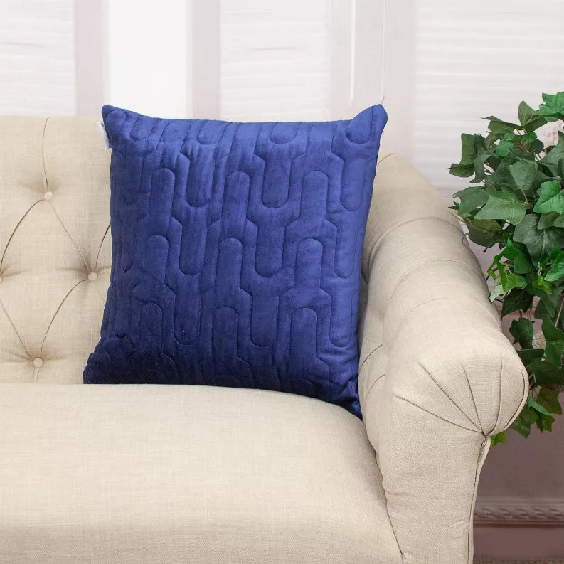 Blue quilted throw pillow with piped edges and repeating U-shaped quilting
