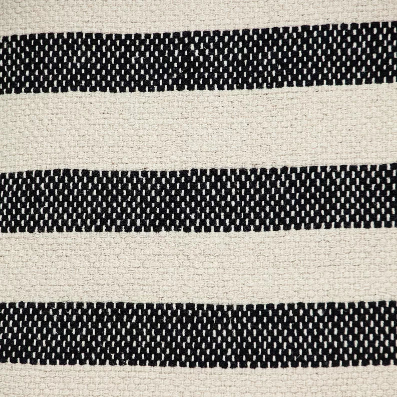 Close-up of beige decorative pillow cover with alternating black striped woven texture