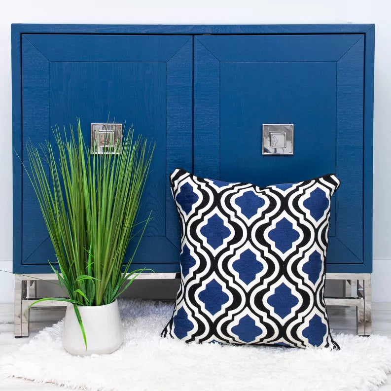 Blue and white geometric square pillow with dark trim and corner piping