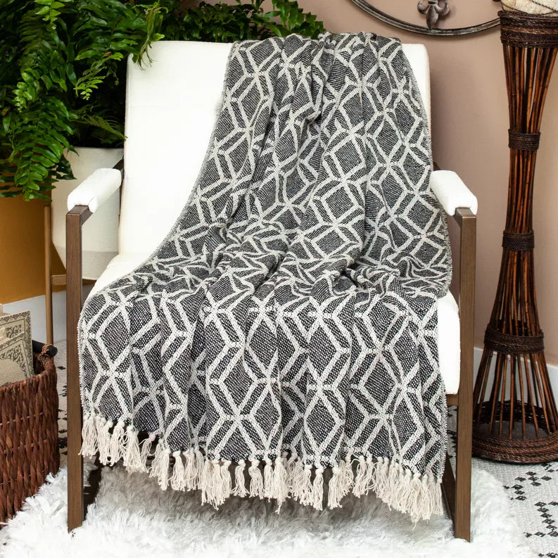 Woven throw blanket with diamond geometric pattern, dark gray and light beige, tassel fringe