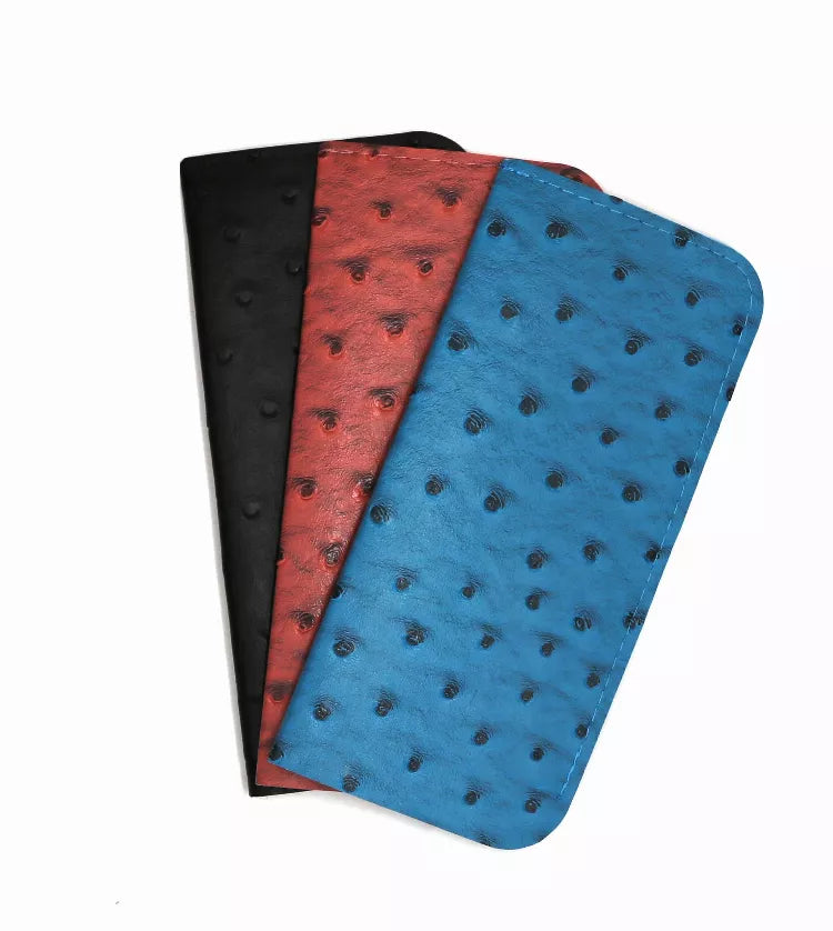 Stacked sunglasses pouches in blue, red, and black with patterned fabric.