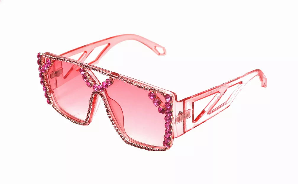 Red sunglasses with pink lenses and rhinestone-trimmed angular frames
