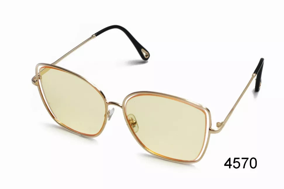 Front view sunglasses with pale yellow tinted lenses, gold metal frame, black temples.