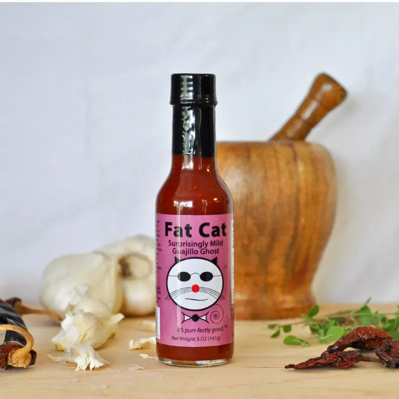 Hot sauce bottle with purple label and black cap