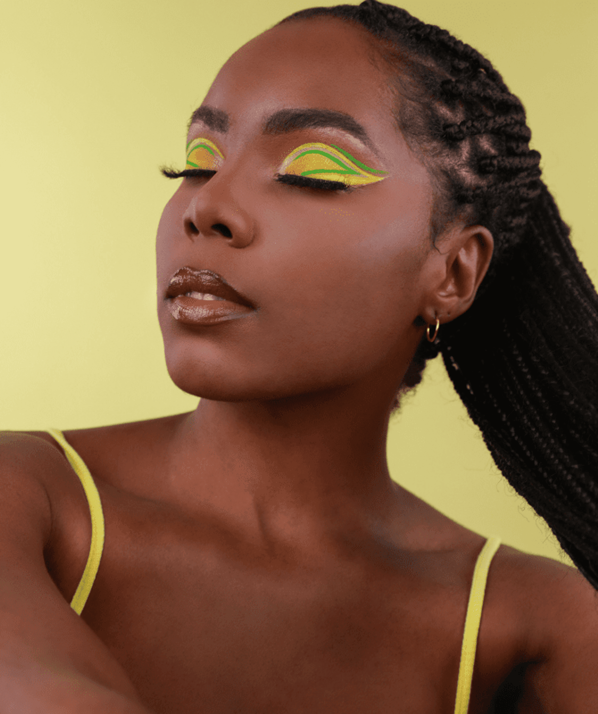 Yellow eye shadow makeup with neon green and yellow graphic liner design