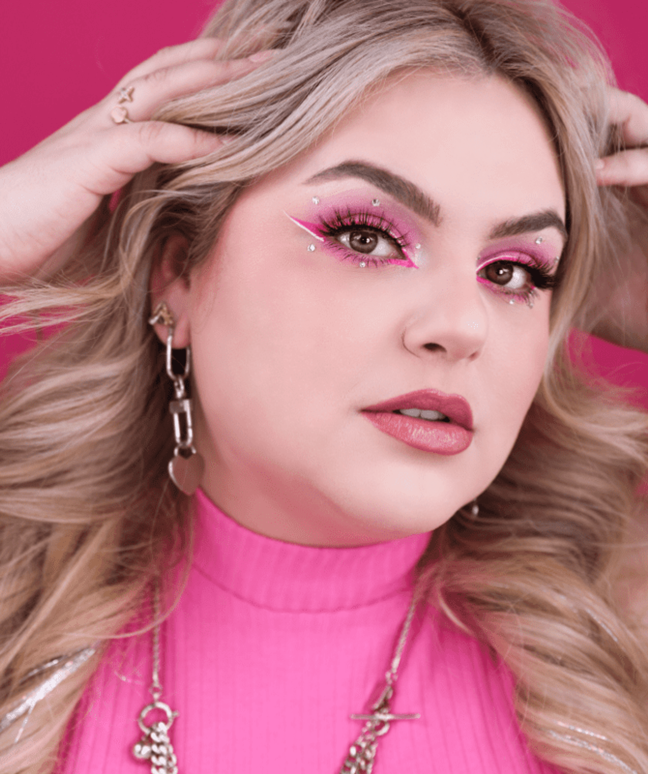 Glitter pink eye makeup look with defined lashes and blended shadow
