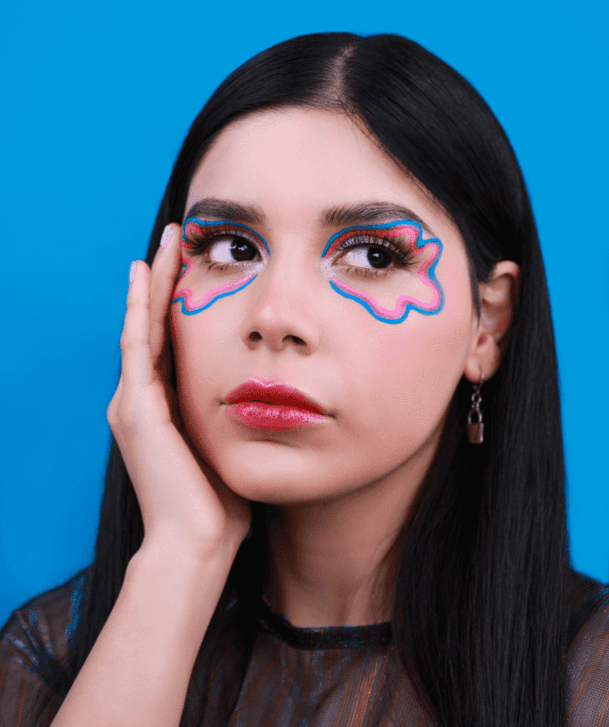 Bold eye makeup with neon blue and pink wing-shaped accents
