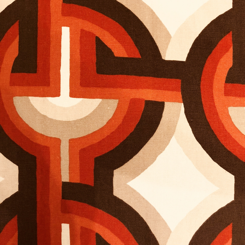 Multicolor luxury throw pillow close-up with Greek key motif in orange, brown, and cream