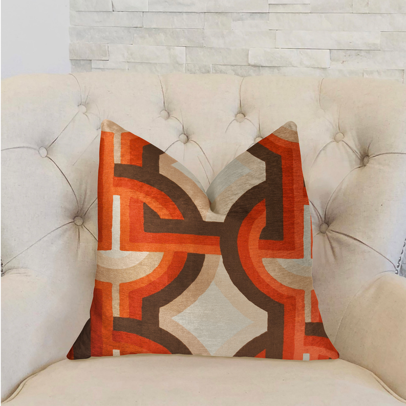 Multicolor luxury throw pillow with bold Greek key pattern in orange and brown on cream sofa