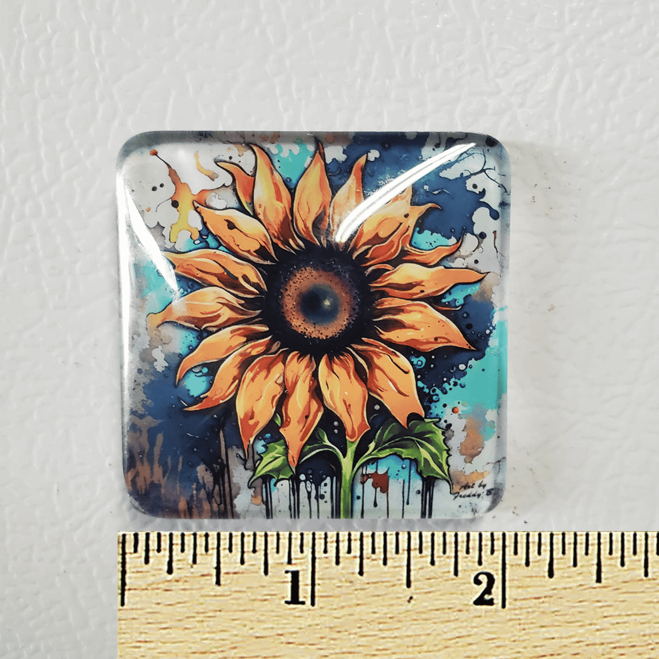 2x2 in square acrylic glass magnet with orange-yellow flower, close-up