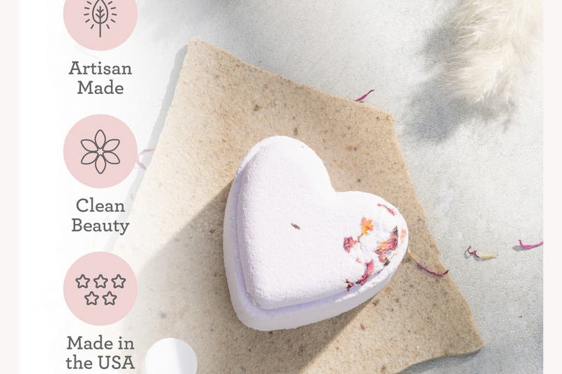 Heart-shaped lavender shower steamer on a textured bath pad