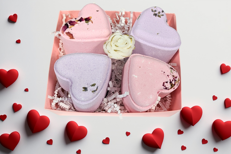 Four heart-shaped shower steamers in pink gift box with red heart decor