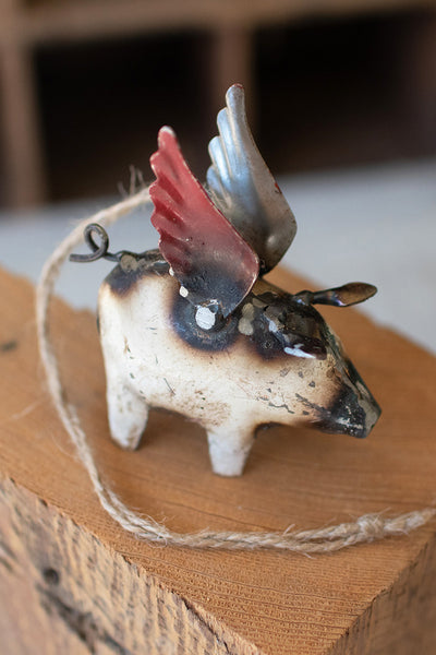 Flying pig Christmas ornament with red and blue wings and wire hanger, iron look