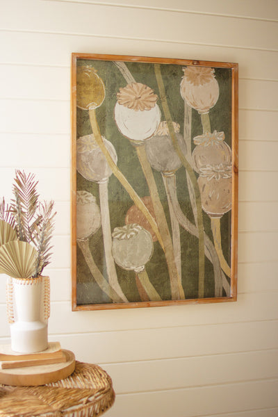 Framed floral print under glass with green leaves and white blossoms, wood border