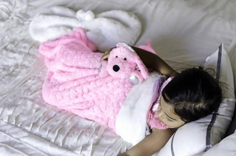 Pink plush heart-shaped blanket with a cute stuffed character face