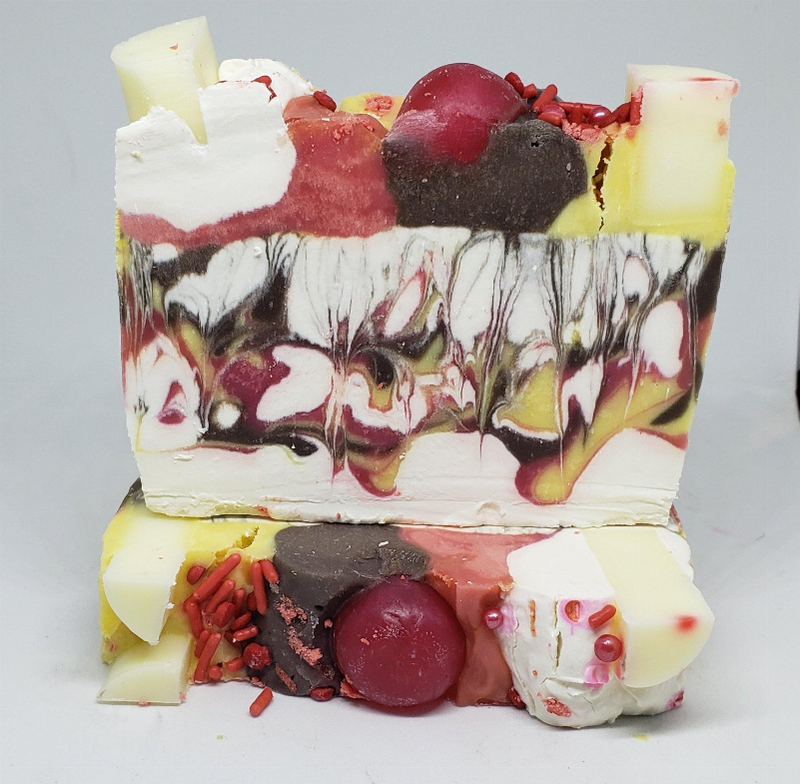 Banana split cream soap with red and black topping, white and yellow layers, rectangular