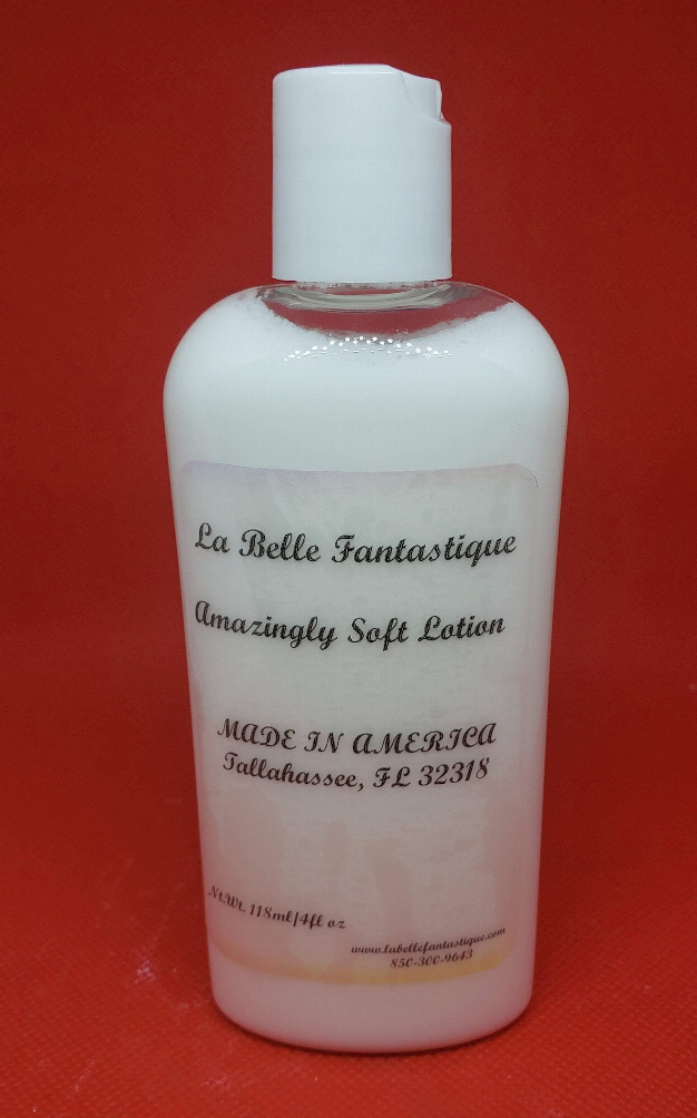 White-capped lotion bottle with pale pink translucent body and printed label