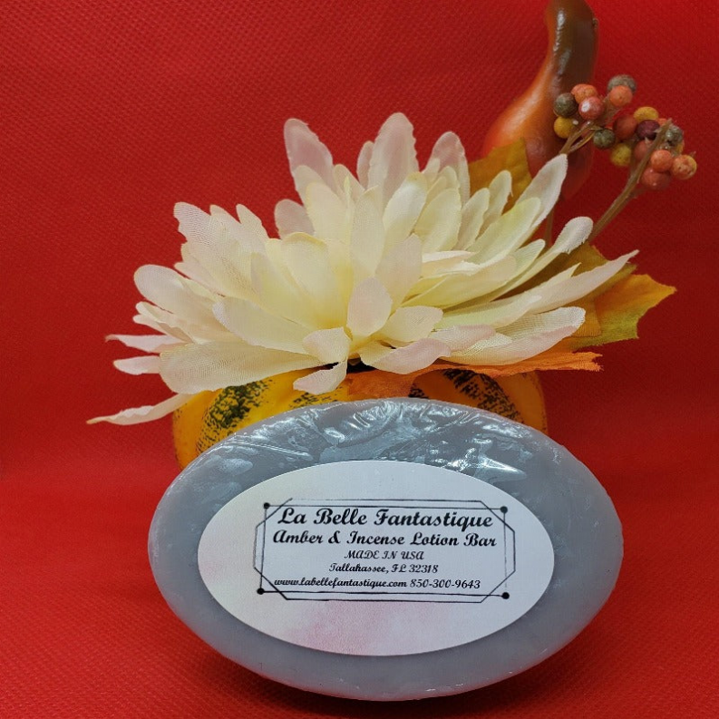 Round blue lotion bar with label; La Belle Fantastique Amber & Incense.