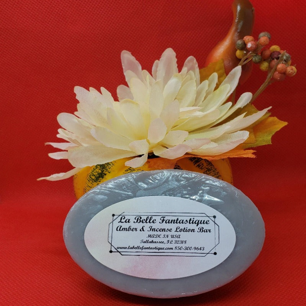 Round blue lotion bar with label; La Belle Fantastique Amber & Incense.