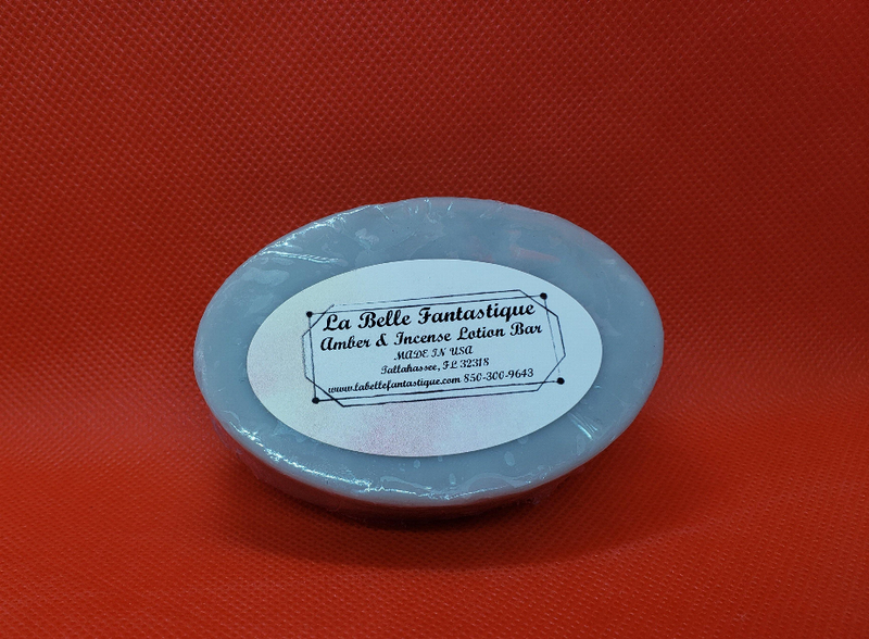 Round blue lotion bar with printed label: La Belle Fantastique.