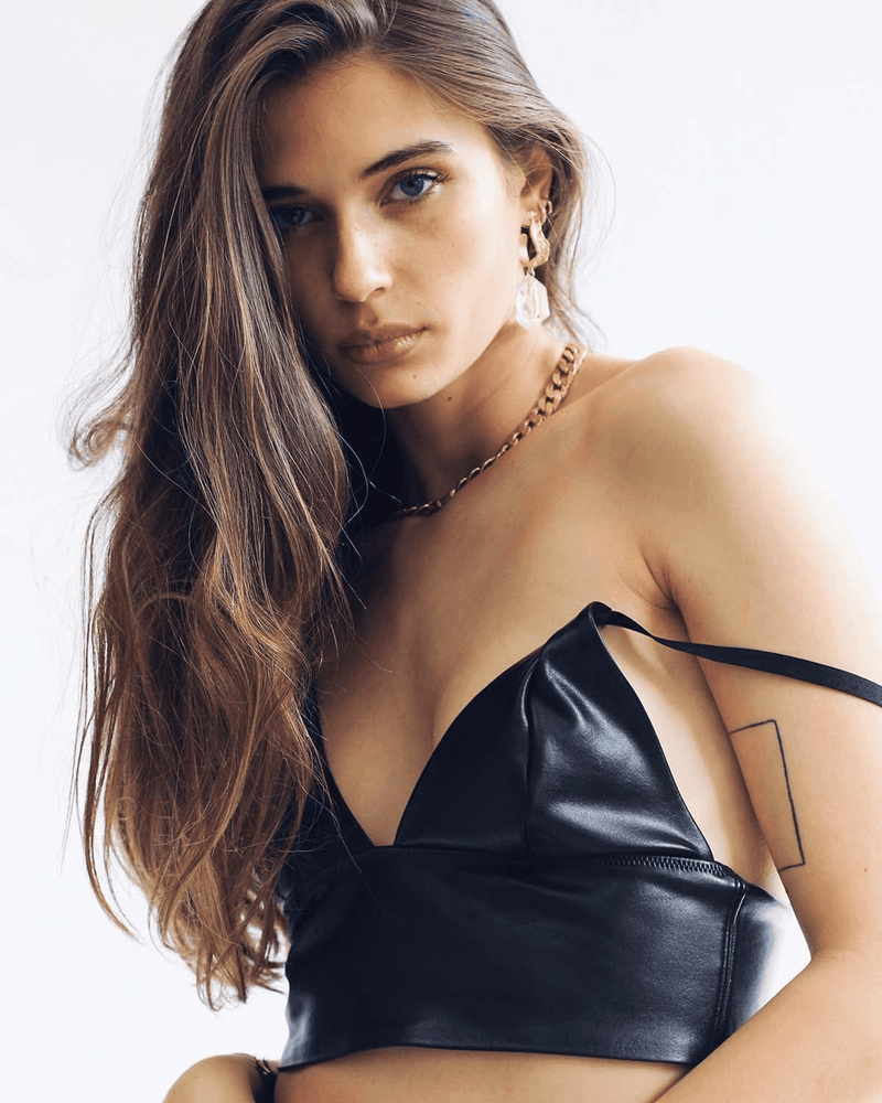 Black satin V-neck crop top with spaghetti straps, side view.