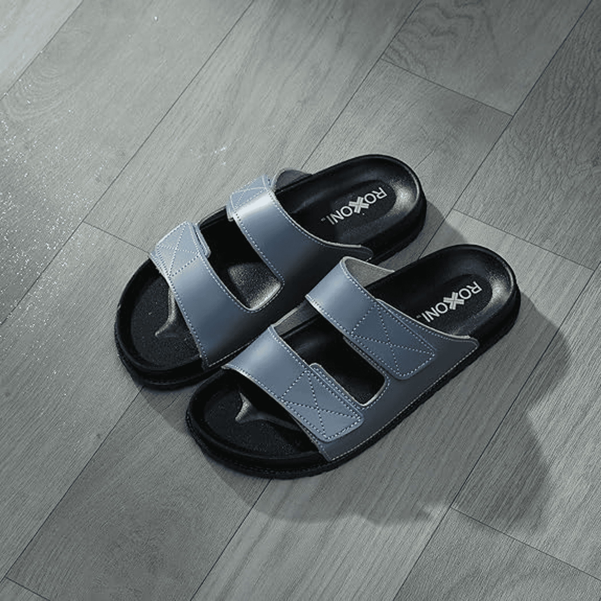 Women’s cushioned two-strap open-toe slide sandals in light blue with cushioned black footbed