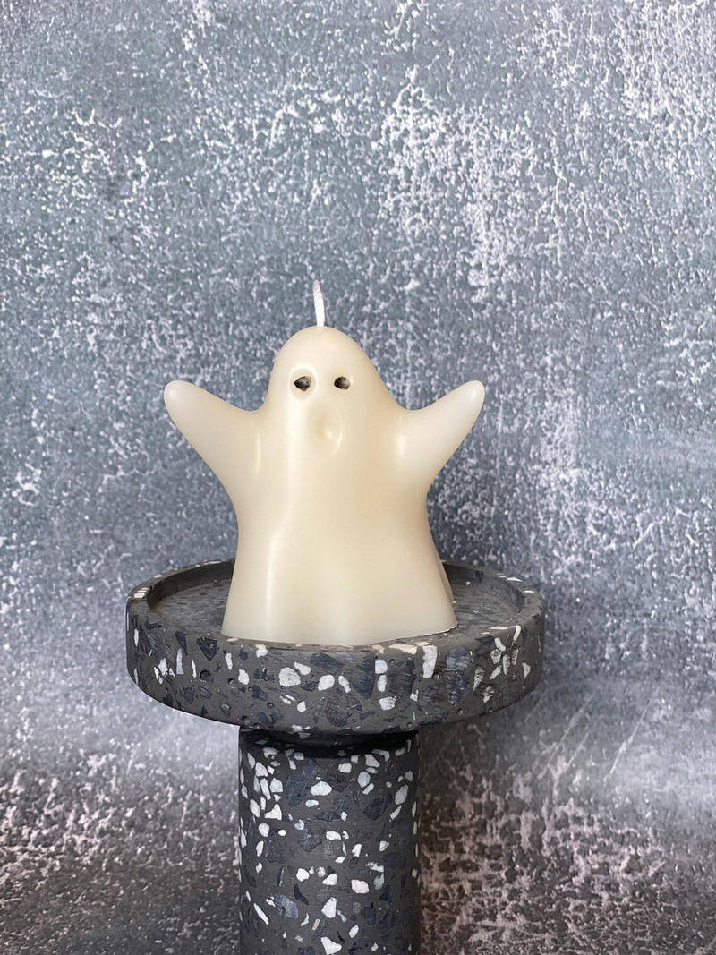 Handmade soy wax ghost candle, ivory smiling ghost with flame on speckled black base