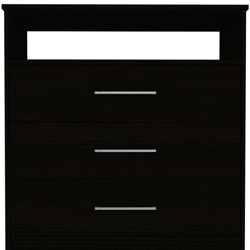 Black four-drawer dresser close-up of three drawer fronts with silver bar pulls
